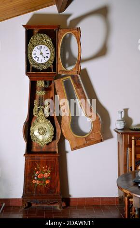 Interior of old apartment with vintage wooden wall clock and antique furniture. Stock Photo