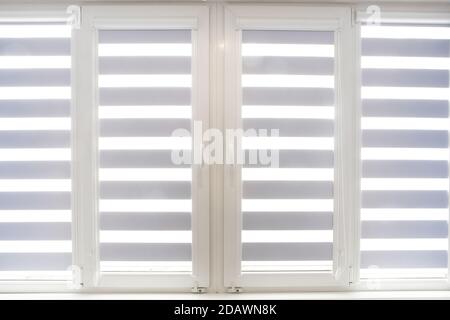 Windows with open modern horizontal blinds indoors, closeup Stock Photo