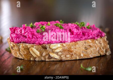 Goat cream cheese mixed with beet spreaded on bread Stock Photo