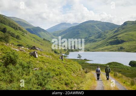 Two walkers heading towards Loch na Leitreach and the Hill An Socach, Scotland. Stock Photo