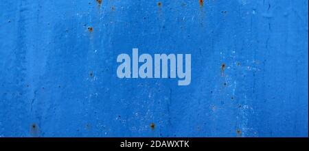 Abstract cracked and scracthed iron rusty wall with blue dry paint Stock Photo