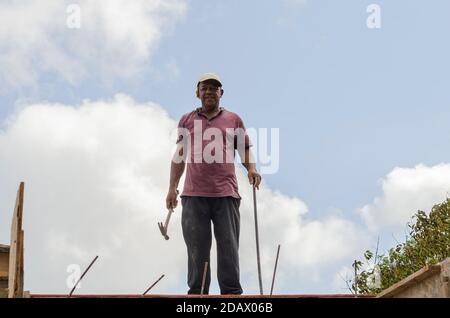 Tradesman Standing On The Top Of A Building Stock Photo