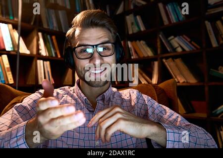 Happy remote tutor talking to cam conference video calling giving online class. Stock Photo