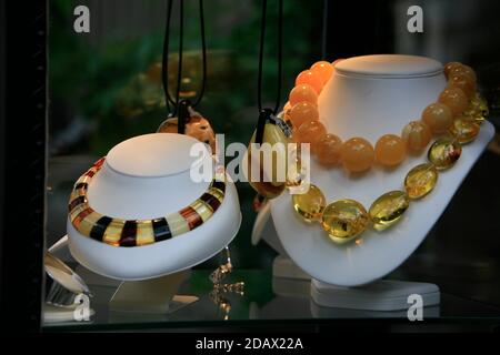 Shop window display of traditional Baltic coast amber jewellery on sale in the Old Town. Stock Photo