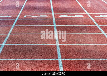 The layout of the track on the sports treadmill with artificial turf is red. Stock Photo