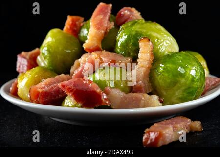 Fried brussels sprouts with bacon on plate Stock Photo