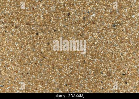 Blank concrete brown rough wall for background. Beautiful brown exposed aggregate wall plastered surface background pattern. Stock Photo