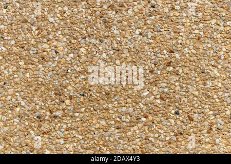 Blank concrete brown rough wall for background. Beautiful brown exposed aggregate wall plastered surface background pattern. Stock Photo