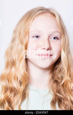 Pre-teen, fair haired youg lady with blue eyes. Stock Photo