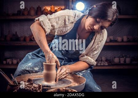 Master class on modeling of clay on a potter's wheel In the pottery workshop. Stock Photo