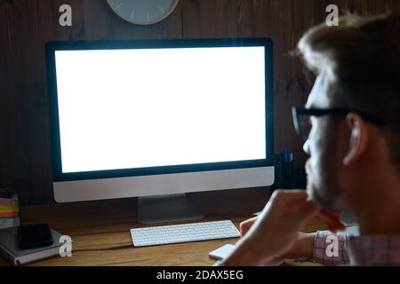 Business man looking at computer mockup white blank screen monitor. Stock Photo