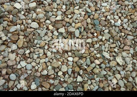 a close up view of a stone pebble rock gravel garden path backyard trail suitable for background backdrop also like a footpath walkway park featuring Stock Photo