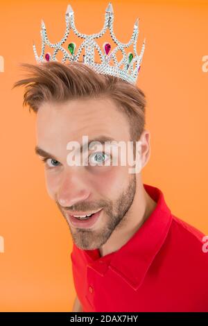 Funky prince. Glory seeking man. Man representing power and triumph. Business king. Cheerful guy wear crown. King of style. Achieving victory and success. Narcissistic prince. Prince golden crown. Stock Photo