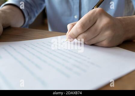 Man hand signing a contract, close up view Stock Photo