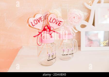 Sweets on a stick in a transparent glass jar valentine's day decoration Stock Photo