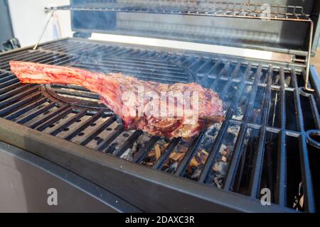 Dry Aged Barbecue Tomahawk Steak on grill Stock Photo