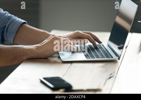 Close up image male hands typing on laptop keyboard Stock Photo