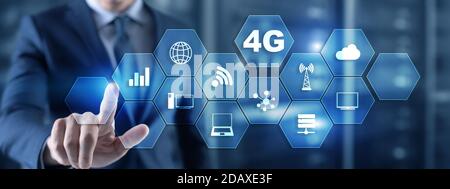 Businessman is pushing his finger on 4G button. Mobile communication concept. Stock Photo