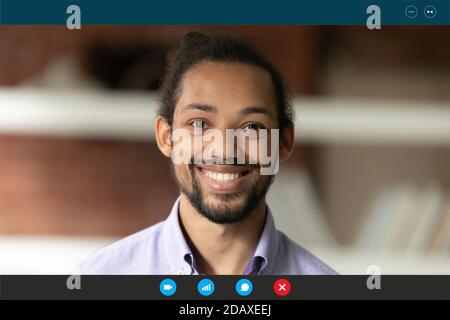 Smiling young african american employee looking at web camera. Stock Photo
