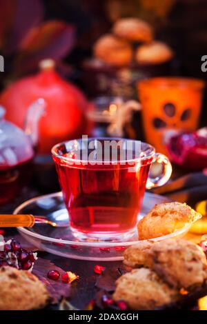 Glass cup of hot red tea and fresh homemade delicious apple cookies on rustic autumn background Stock Photo