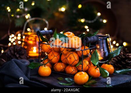 Fresh ripe tangerines with leaves on wooden table Stock Photo