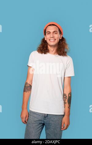 Young adult man looking at camera and smiling wide Stock Photo