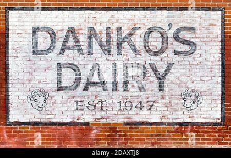 A faded business mural painted on a brick wall for Danko's Dairy est. 1947 in the Longfellow Neighborhood of Minneapolis, Minnesota Stock Photo