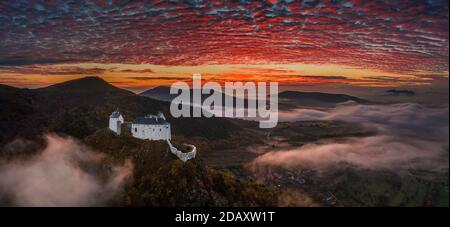 Fuzer, Hungary - Aerial panoramic view of the beautiful Castle of Fuzer with amazing colorful sunrise sky and clouds on an autumn morning. The castle Stock Photo