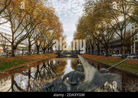 Outdoor and Diminishing perspective view over the canal at Königsalle, renowned luxury shopping district in autumn season. Stock Photo