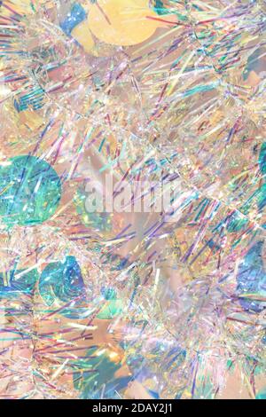 Christmas tinsel garland texture abstract background in pastel colors. Stock Photo
