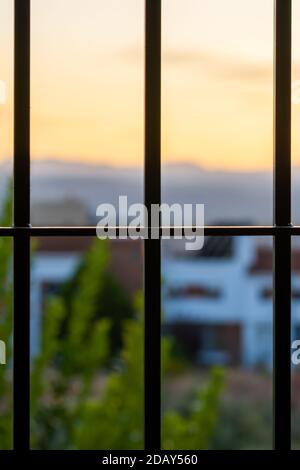 View behind the window bars at home due to the coronavirus pandemic Stock Photo