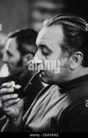 Fine 1970s vintage black and white photography of a smoker smoking in public. Stock Photo