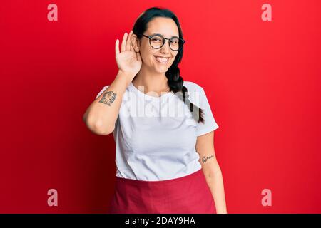 Young hispanic woman wearing professional waitress apron feeling unwell and coughing as symptom for cold or bronchitis. health care concept. Stock Photo