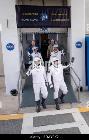 NASA astronauts Victor Glover, front left, Mike Hopkins, front right, Shannon Walker, back left, and Japan Aerospace Exploration Agency (JAXA) astronaut Soichi Noguchi, back right, wearing SpaceX spacesuits, are seen as they walkout of the Neil A. Armstrong Operations and Checkout Building to depart for Launch Complex 39A to board the SpaceX Crew Dragon spacecraft for the Crew-1 mission launch, on November 15, 2020, at NASA's Kennedy Space Center in Florida. NASA's SpaceX Crew-1 mission is the first crew rotation mission of the SpaceX Crew Dragon spacecraft and Falcon 9 rocket to the Internat Stock Photo