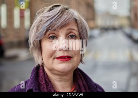 Beautiful aged woman's with short hair portrait outdoors. Stock Photo