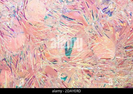 Christmas tinsel garland texture abstract background in pastel pink colors. Stock Photo