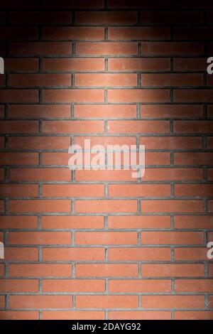 Vertical brick wall texture with light from above Stock Photo