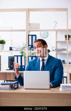 Young male employee sitting in the office Stock Photo