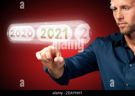 man is using virtual interface to select 2021 on red background Stock Photo