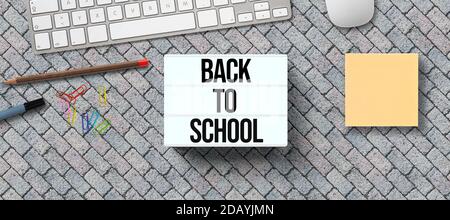 message BACK TO SCHOOL on lightbox with utensils on stone pavement background Stock Photo