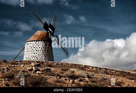 An approaching storm over a traditional windmill on Fuerteventura Stock Photo