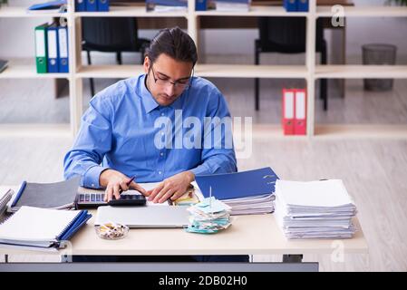 Young bookkeper in budget planning concept Stock Photo