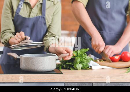 Young couple cooking dinner in kitchen Stock Photo
