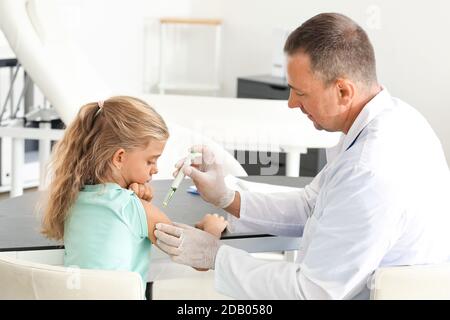 Doctor giving diabetic girl insulin injection in clinic Stock Photo
