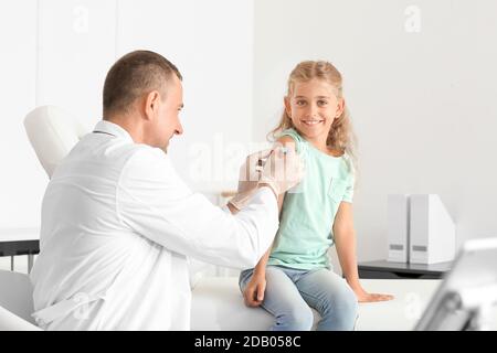 Doctor giving diabetic girl insulin injection in clinic Stock Photo