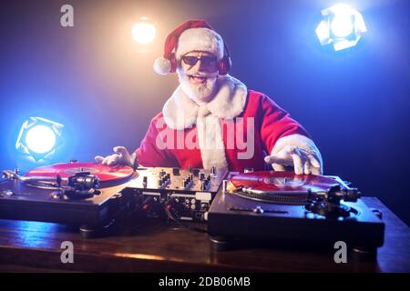 Cool Santa DJ playing music in club Stock Photo