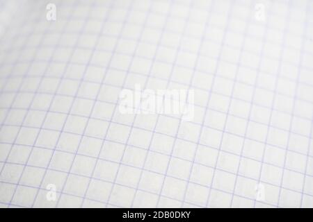 blurred background of a checkered notebook sheet. Stock Photo