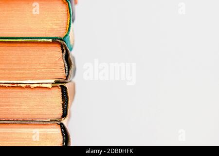 Close-up of stack of old used books background. Pile of vintage old hardback books. Back to school. Copy space Stock Photo