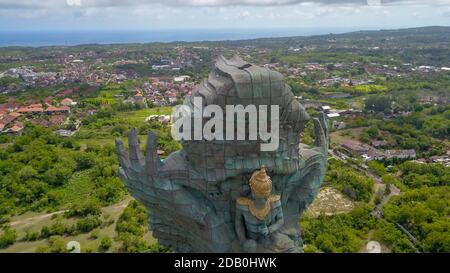 Landscape picture of tallest Garuda Wisnu Kencana GWK statue as Bali landmark with blue sky as a background. Balinese traditional symbol of hindu Stock Photo
