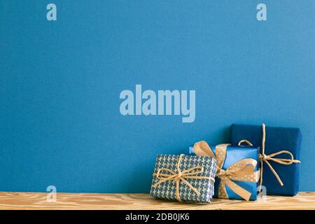 Blue gift boxes on wooden table with blue background Stock Photo